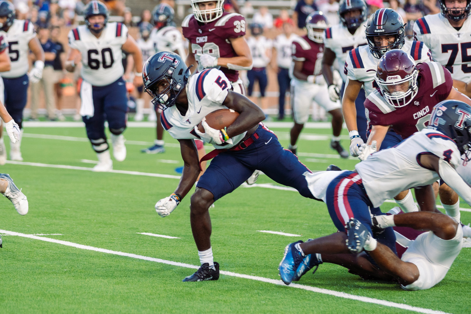 Tompkins’ Jhase McMillan breaks a tackle during Friday’s game between Cinco Ranch and Tompkins at Rhodes Stadium.